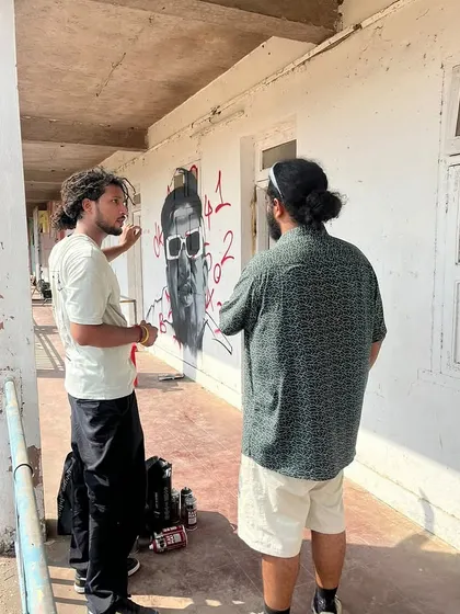 Me explaining the Naezy portrait to him on the set of the music video. It's always cool when the person you paint gets to see it in person.