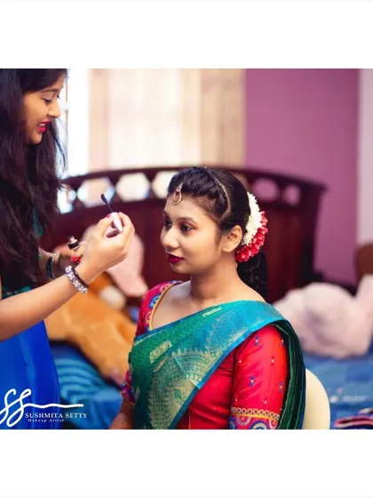 A behind-the-scenes moment of me applying the final touches. Creating a comfortable and fun atmosphere is just as important as the makeup itself.