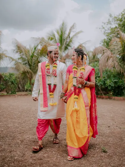 A full-length shot of the couple walking hand-in-hand after their wedding.