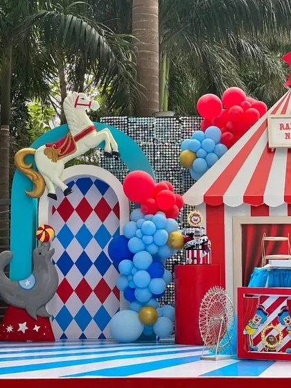 Another look at the whimsical carnival setup, featuring a carousel horse and a playful seal. The combination of red, white, and blue with classic circus patterns created a lively and exciting atmosphere for all the guests.