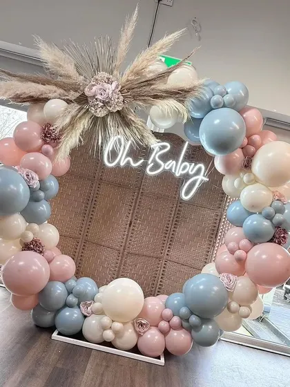 Another angle of the circular rattan backdrop. The pampas grass and muted pink and blue balloons add to the soft, bohemian vibe.