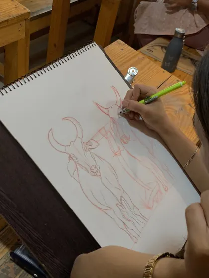 A student adds detail to their freehand sketch of bulls. This practice is not just about copying, but about understanding the underlying structure and expressing it through confident lines.