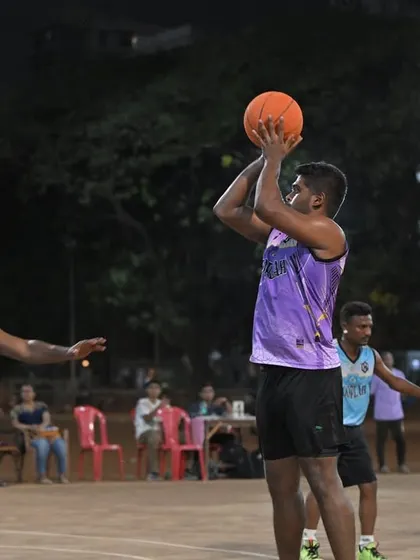A player rises for a jump shot over the defense. Capturing the skill and athleticism on display at our men's league games.