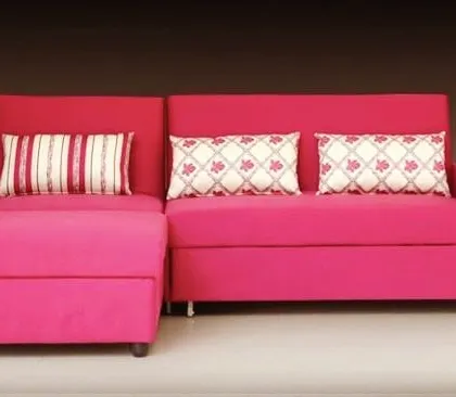 This bright pink sofa with a chaise lounge is a fun and functional piece. It's perfect for adding a vibrant splash of color to a room while providing a comfortable spot to stretch out and relax. The included patterned cushions complete the playful look.