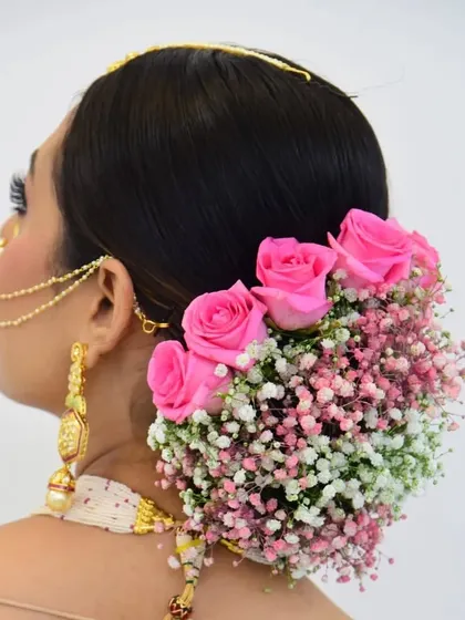 A classic floral bun is always a beautiful choice for traditional events. I created this intricate low bun and adorned it with a combination of fresh pink roses and baby's breath, ensuring it looks stunning from every angle.
