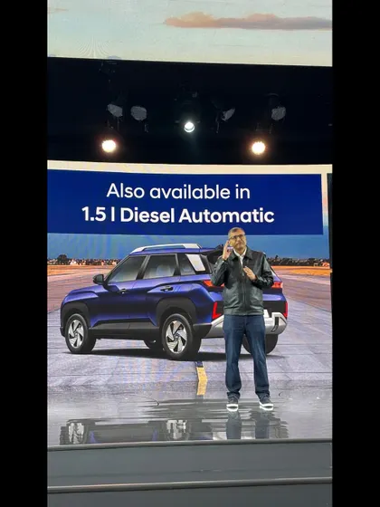 A speaker on stage at the Hyundai Venue launch, with the vehicle visible in the background. We managed the teleprompter and all on-stage technicals for a seamless presentation.