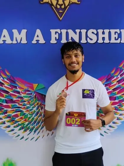 Proudly showing off a medal after the 4K run at Bangalore University.