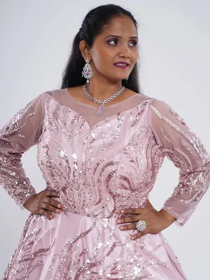 Another look at the pink sequin and motiwork ball gown. The full sleeves and intricate patterns make it a grand and elegant choice for any formal occasion.