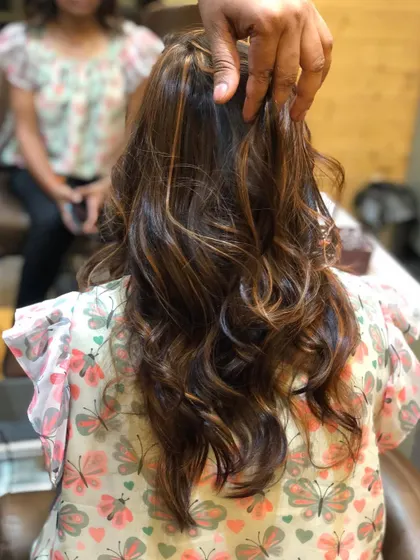 The final result of the subtle highlights, styled with soft waves to catch the light.