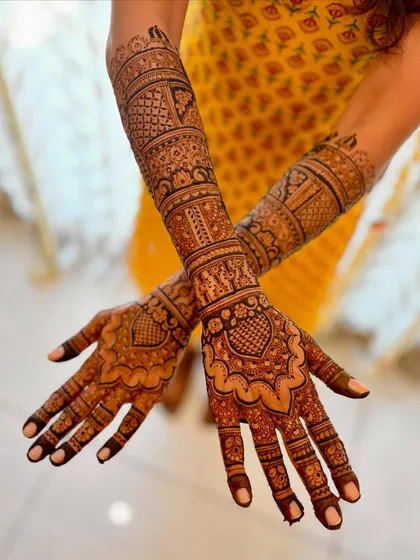 A crossed-arm pose of the back of the hands, showing the full extent of the heart-themed design.