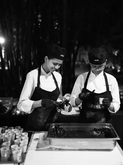 Two of our female chefs smiling while working together at a dessert station.