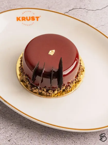 Another view of the Cherry and Chocolate pastry, showcasing its elegant shape and flawless finish. A perfect little indulgence.