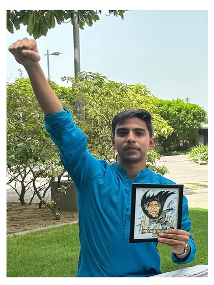The hero himself! A proud client posing with his custom Batman caricature, striking a power pose that matches the artwork perfectly.