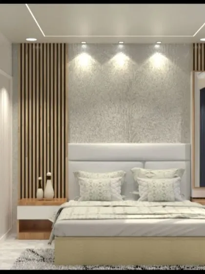 A bedroom with a textured concrete-finish accent wall and a wood-panelled headboard.