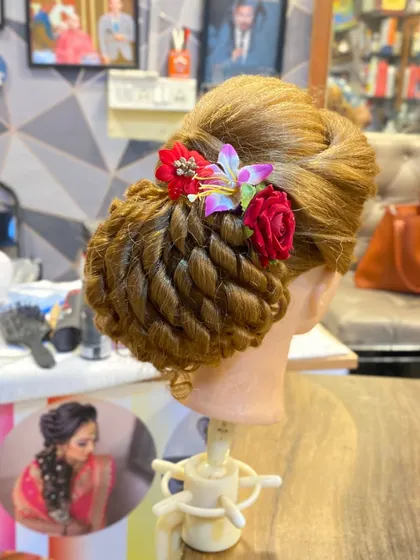 A final close-up of the student's bridal bun, demonstrating the professional quality they achieve by the end of the course.