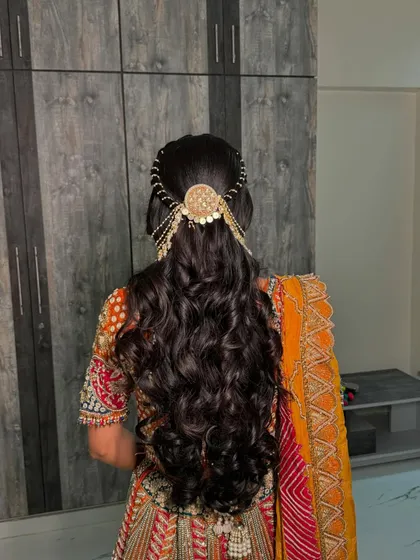 A back view of this bride's engagement hairstyle. We chose open curls with a stunning traditional accessory that drapes beautifully over her hair.