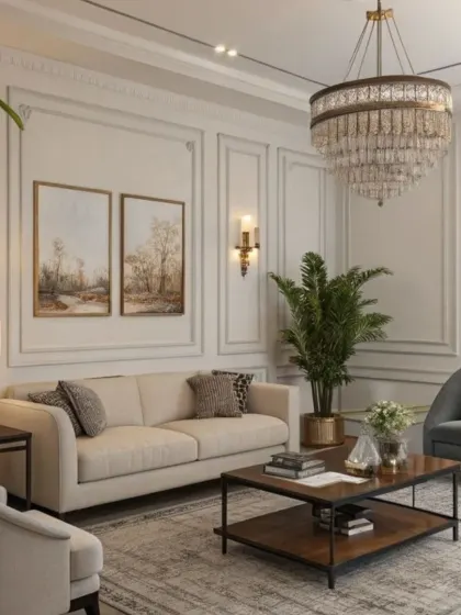 We brought a touch of classic elegance to this living room with detailed wall paneling and traditional furniture silhouettes. A grand crystal chandelier and wall sconces provide warm, layered lighting, creating a formal yet welcoming atmosphere.
