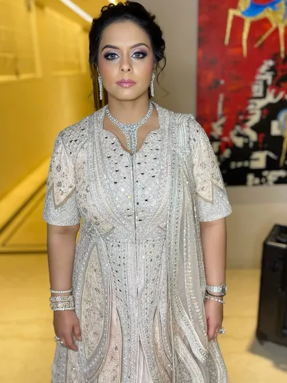 A stunning look for a family wedding, featuring a soft purple and pink smokey eye that complements her embellished outfit.