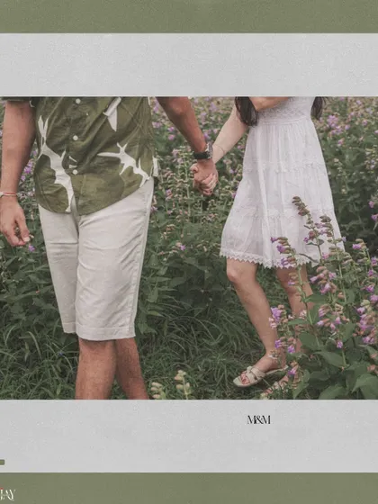 A detail shot of the couple holding hands as they walk through the flowers.