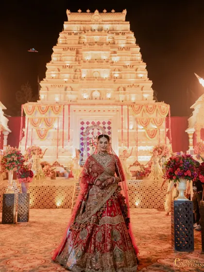 A portrait of the bride, her regal attire perfectly complementing the grandeur of the Mysore Mandira backdrop. My designs aim to create a world where every element, including the couple, feels part of a cohesive, beautiful story.