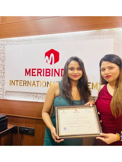 Another student receives her certificate, ready to turn her passion for beauty into a profession.