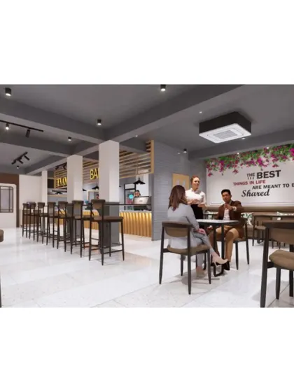 An overall view of the cafe's seating plan, showing a mix of table sizes and seating styles to accommodate various guests.