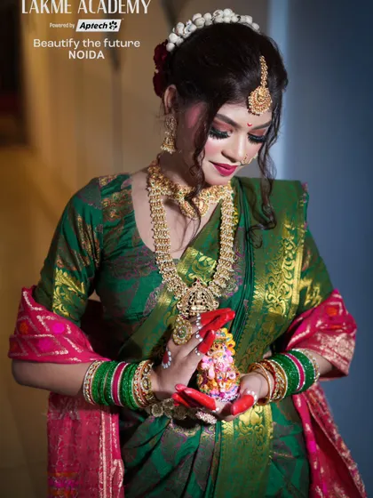 A beautiful shot of our model holding a small Ganesha idol, perfect for a festive-themed shoot. The makeup is traditional, with an emphasis on the eyes and gold jewelry.