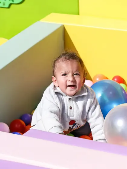 Just look at that happy face! Our ball pits are a huge hit with the tiniest party guests.