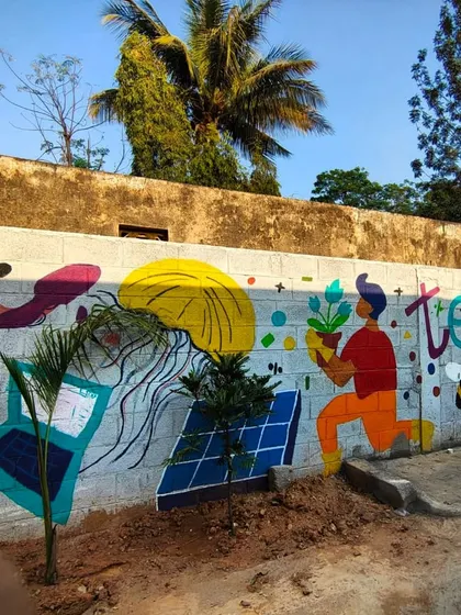 Another part of the Project Defy mural, with the words "Together We" and symbols of nature and technology, reflecting the community's vision.