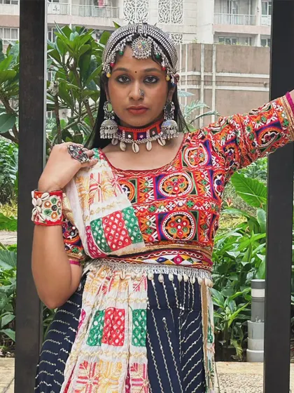 A front view of the patchwork blouse and the layered jewelry, showing how to create a bold, traditional look.