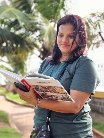 A reader enjoying 'Memories on a Plate' outdoors. It's beautiful how books travel across generations and find new homes.