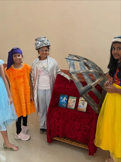 Our students proudly stand by the props they helped create. In our Group Drama sessions, every student is involved in the production, from performance to prop design, fostering a sense of ownership and teamwork.