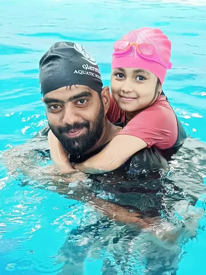A happy student gets a piggyback ride from her coach, showcasing the fun and trusting relationship we build.