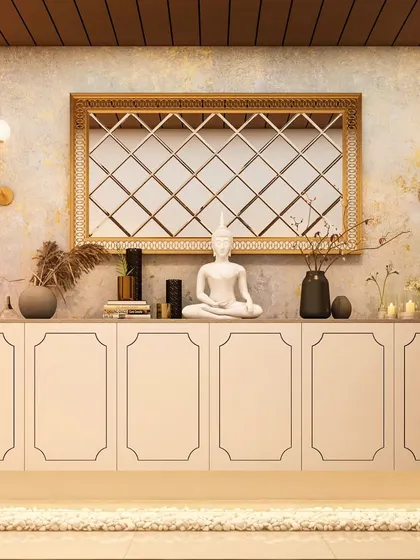 A serene and spiritual entryway console. The floating white cabinet is decorated with a Buddha statue and other calming artifacts, set below a large, gold-framed mirror with a diamond pattern.