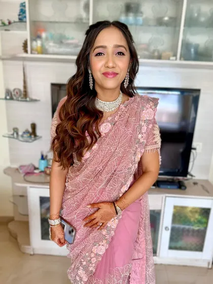 The full look, showcasing the beautiful pink saree and the soft, romantic makeup and hairstyle.