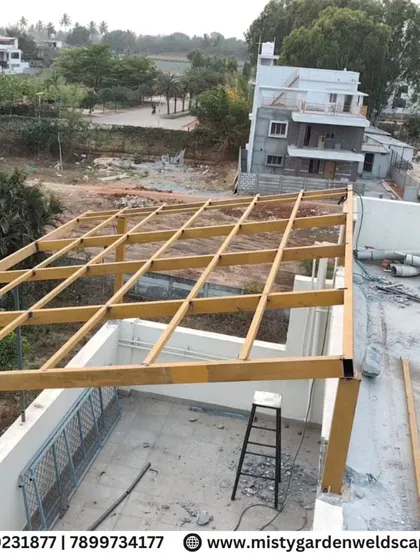 An overhead view of the pergola framework being installed on a rooftop. This shows the grid system that will support the roofing material.