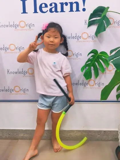 A happy student poses after a fun day of learning and building at our workshop.