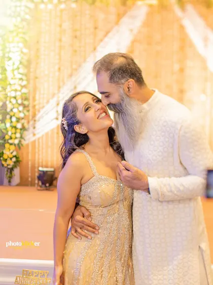 A candid, affectionate moment between a father and daughter during a family celebration. We capture the bonds that span generations.