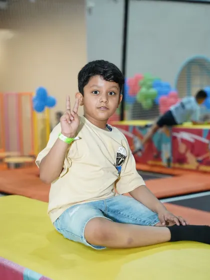 A young boy flashes a peace sign, perfectly capturing the fun and carefree vibe of our play space.