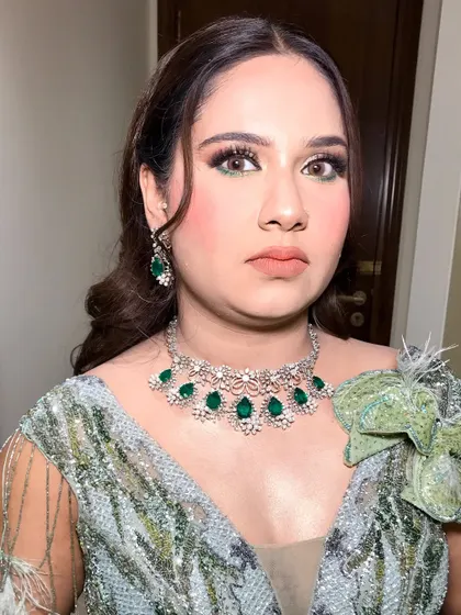 A pop of green divine. This look features metallic eyeshadow and ombré lips, paired with a stunning green and silver gown.