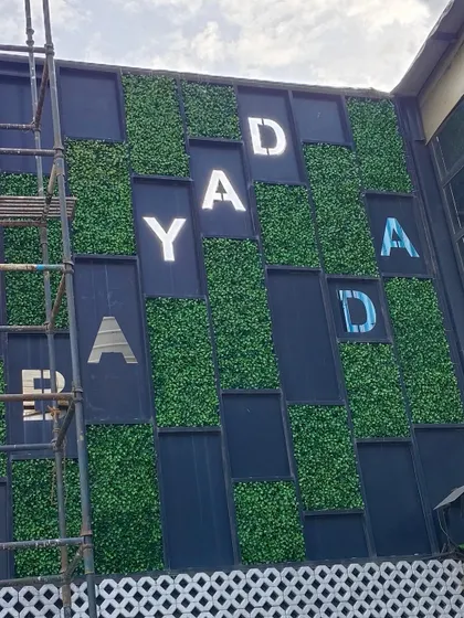 We work with businesses to integrate their branding into green designs. For the Bombay Adda facade, we installed custom-cut artificial grass panels to create a memorable and eye-catching entrance.