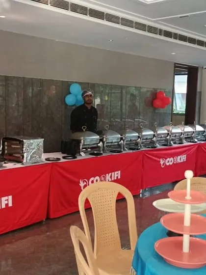 A colorful and inviting setup for a birthday party, complete with a tiered stand for desserts or snacks, ready to delight guests.