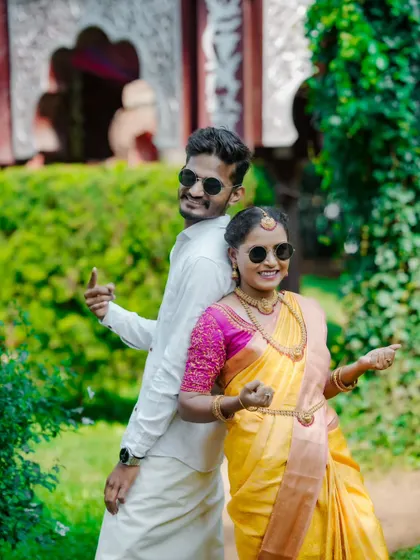 A fun and cool back-to-back pose with sunglasses. This shows the couple's playful side during their traditional pre-wedding shoot.