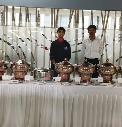 Our team stands ready to serve at a corporate lunch. This image shows a full buffet line with our staff ensuring everything runs smoothly, reflecting our commitment to professional service.