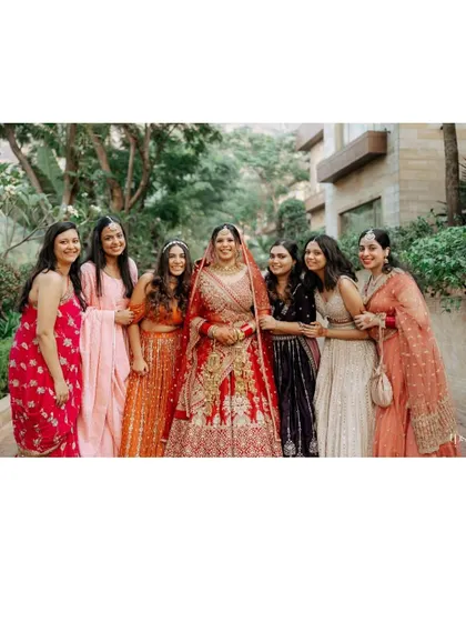 The bride surrounded by her beautifully dressed bridesmaids, a perfect portrait of friendship and celebration.