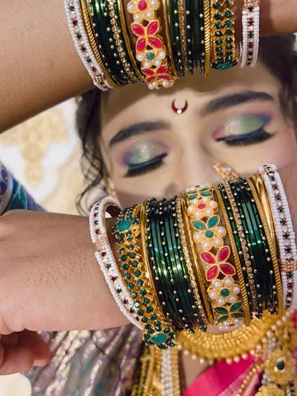 A detailed shot of the bride's eyes and the beautiful green bangles, an important part of the Maharashtrian bridal attire.
