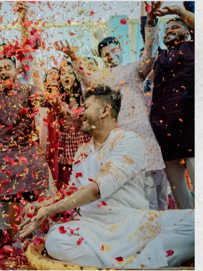 A shower of flower petals for the groom. This action shot from Saloni and Vatsal's Haldi is full of movement and joy, capturing the celebratory spirit of the event.