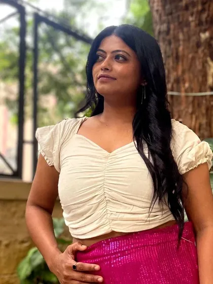 A trendy and chic fusion look. This client is wearing a simple ruched crop top paired with bright pink sequined pants that I designed.