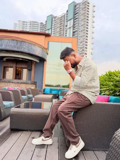 A thoughtful pose against a city backdrop.