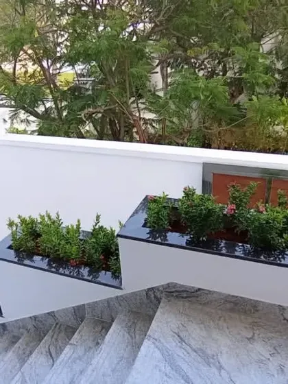 I design and install greenery for all parts of a home, including these modern, built-in planter boxes along a staircase.